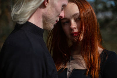 Couple embracing in park during autumn