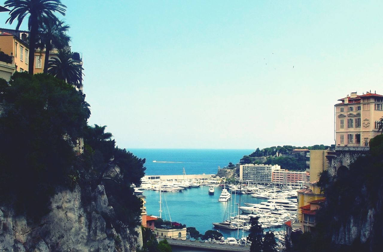 sea, water, horizon over water, clear sky, building exterior, architecture, built structure, copy space, beach, blue, bird, flying, coastline, nautical vessel, scenics, city, shore, nature, outdoors, day