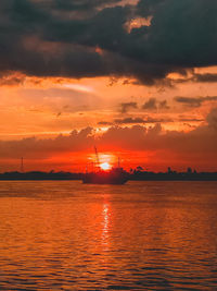 Scenic view of sea against orange sky