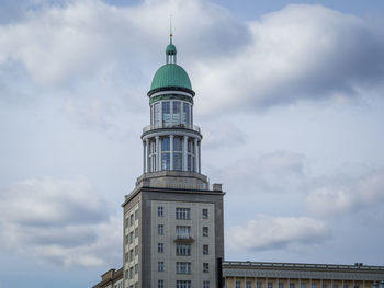 Low angle view of building against cloudy sky