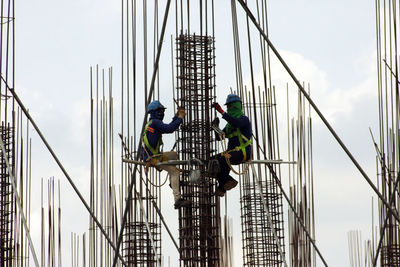 Low angle view of people working at construction site