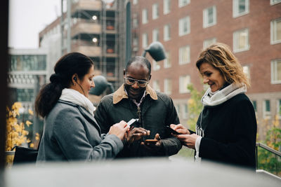 Group of people sitting in front of building