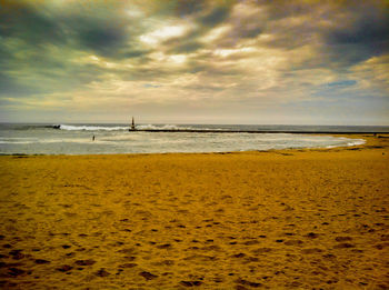 Scenic view of sea against cloudy sky