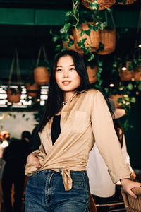 Portrait of smiling young woman standing outdoors