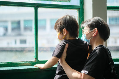 Friends sitting at window