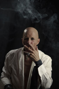 Portrait of man smoking cigarette