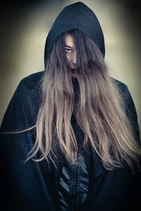 Close-up of young woman with arms hair at night