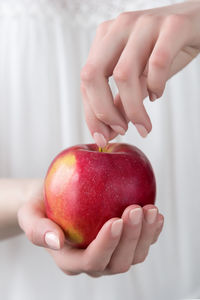 Midsection of woman holding apple