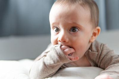 Portrait of cute baby lying on bed