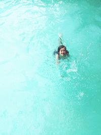 Portrait of smiling young woman swimming in pool