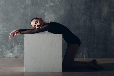 Side view of gymnast on floor against sky