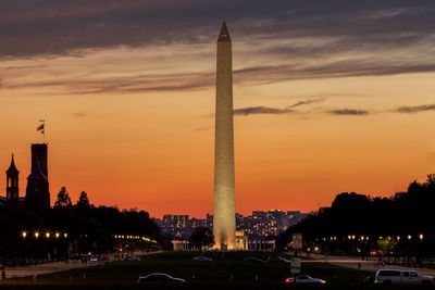 View of city against cloudy sky during sunset