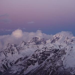 Scenic view of snow covered mountains against sky