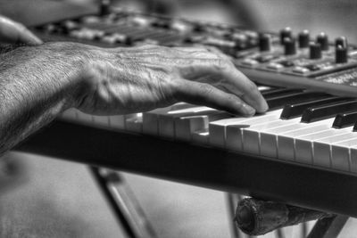 Side view of hands playing the organ