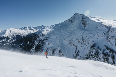 Woman ski touring in stormy weather in the austrian alps, gastein, salzburg, austria