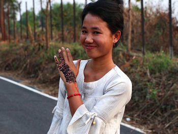 Portrait of teenage girl standing on land