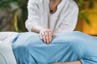 Midsection of woman getting massage at spa