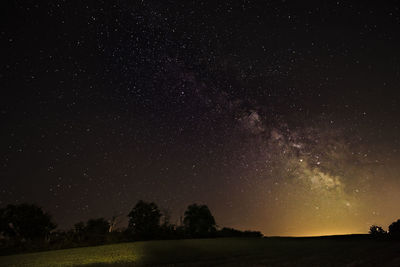 Scenic view of field against sky at night