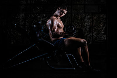 Shirtless muscular man exercising in gym