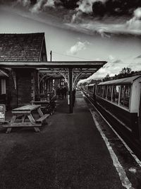 Empty railroad station platform against sky