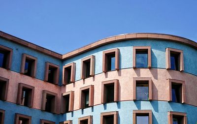 Low angle view of building against clear blue sky