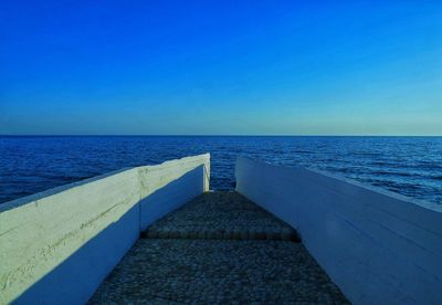 Scenic view of sea against clear blue sky