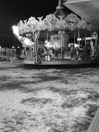 Illuminated amusement park against sky at night