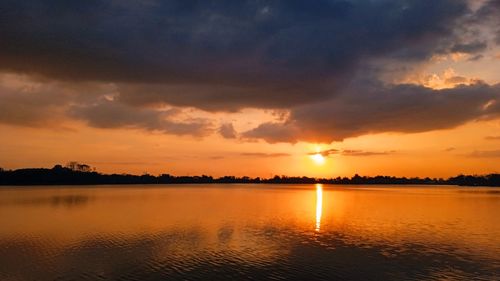 Scenic view of lake against sky during sunset