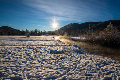 Scenic view of snowcapped mountains against sky during winter