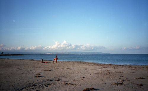 Scenic view of beach against blue sky