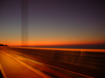 Cars on road at sunset