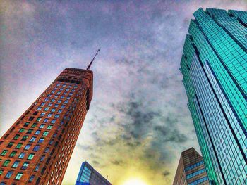 Low angle view of buildings against cloudy sky