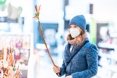 Man holding umbrella standing in winter