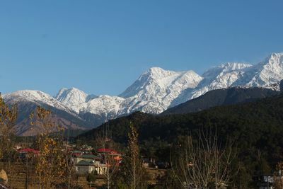 Scenic view of snowcapped mountains against clear sky