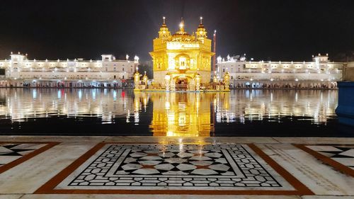 Reflection of illuminated building in water at night