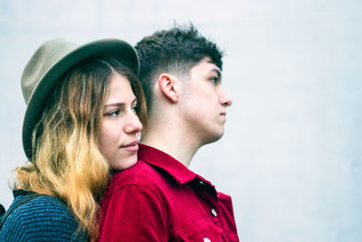 Portrait of young couple looking away in winter