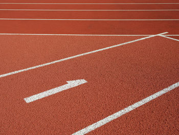 High angle view of a number 1 on the running lane of an athletics track