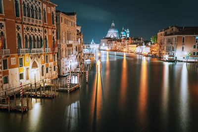 Grand canal amidst illuminated buildings in city at night