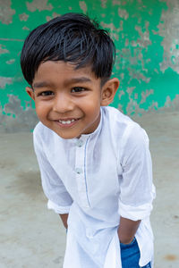 Portrait of smiling boy standing outdoors