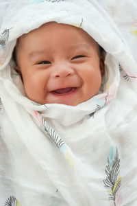 Portrait of cute baby girl on bed