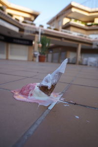 Close-up of paper toy against building in city