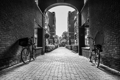 Footpath amidst buildings in city