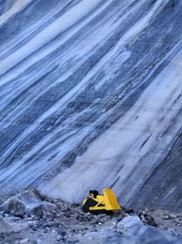 Yellow umbrella on frozen water