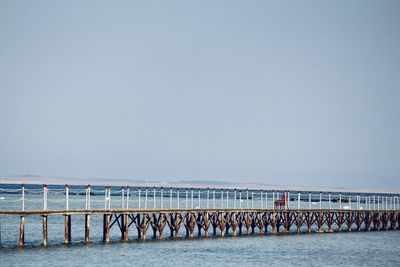 Pier over sea against clear sky