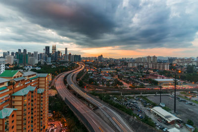 High angle view of city street and buildings against sky