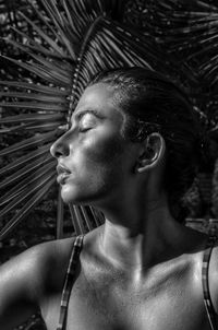 Close-up of a young woman with closed eyes outdoors