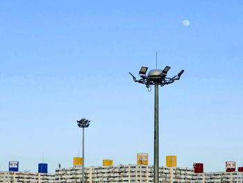 Low angle view of street lights against buildings in city