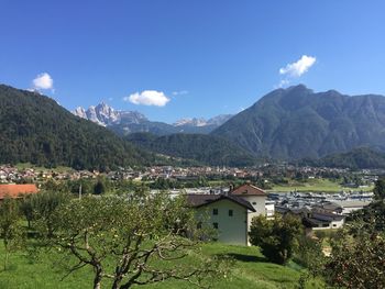 Scenic view of mountains and buildings against sky