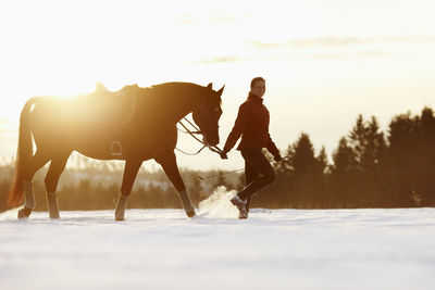 Woman walking with horse