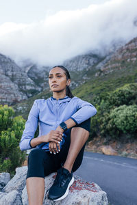 Portrait of man sitting on mountain